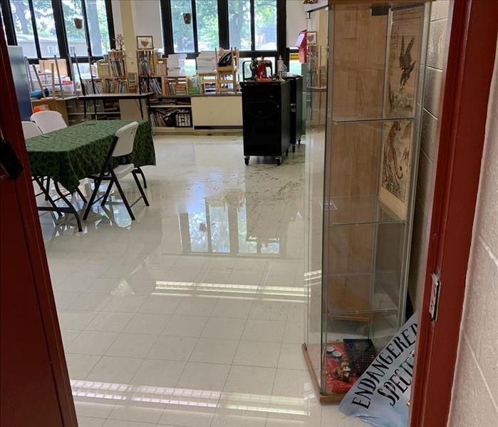 This is an example of water damage before we started the mitigation.  Water has spread all across the floor of the classroom.